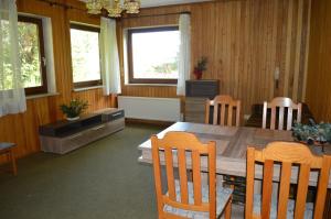 a dining room with a wooden table and chairs at Apartman Kammleitn in Hermagor