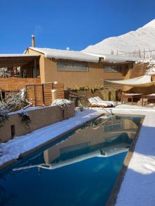 a house with a swimming pool in the snow at UMA Hotel in Pisco Elqui