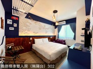 a hotel room with a bed and a couch at Summer Bay Inn in Hengchun South Gate