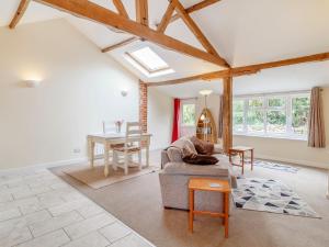 a living room with a couch and a table at The Hen House in Diss