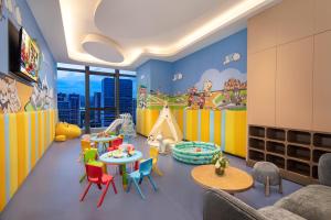 a childs play room with colorful chairs and tables at Ascott M-City Foshan in Foshan