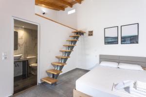 a bedroom with a bed and a spiral staircase at Spitakia-Cozy & Comfy Apartments 10minutes from the airport in Artemida