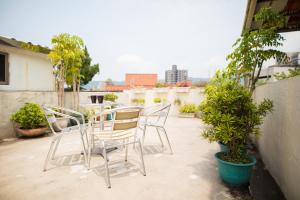 a group of chairs and a table on a patio at On My Way - Taipei Hostel in Taipei