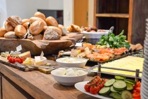 a buffet with many different types of food on a table at Flatbook - City Center Apartments Dwie Motławy in Gdańsk