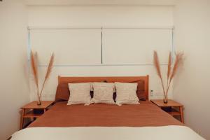 a bedroom with a large bed with two vases at Stylish Luxury Condo in the heart of Playa in Playa del Carmen +22 photos