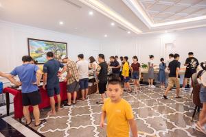 a group of people standing in a room at RUBY QUEEN Hotel in Ha Long