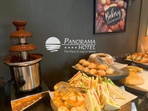 a buffet with sandwiches and other food on a table at Panorama Hotel - Free EV Charging Station in Varna City