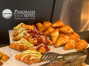 a bunch of pastries and croissants on a table at Panorama Hotel - Free EV Charging Station in Varna City