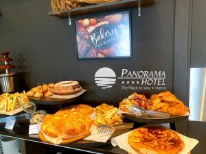 a table with different types of bread and pastries at Panorama Hotel - Free EV Charging Station in Varna City