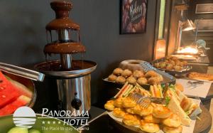 a buffet with sandwiches and other food on a table at Panorama Hotel - Free EV Charging Station in Varna City