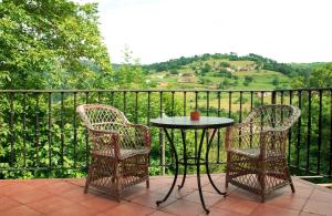 a table and two chairs on a balcony with a view at Casa Canela in Colladas