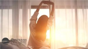 a woman is doing a handstand in front of a window at Panorama Hotel - Free EV Charging Station in Varna City