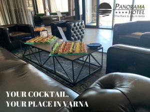 a coffee table with food on it in a lobby at Panorama Hotel - Free EV Charging Station in Varna City
