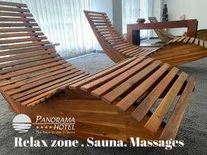 a wooden rocking chair sitting in a room at Panorama Hotel - Free EV Charging Station in Varna City