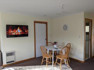 a living room with a fireplace and a dining room table at Smugglers Rest Apartments Dover in Dover