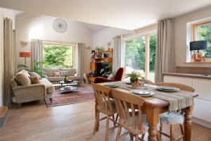 a kitchen and living room with a table and chairs at Sunnybrook - A luxurious Carbon Neutral House close to beach, Shaldon in Shaldon