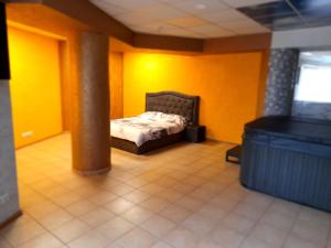 1 dormitorio con 1 cama en una pared amarilla en Jacuzzi Apartament Old town en Klaipėda