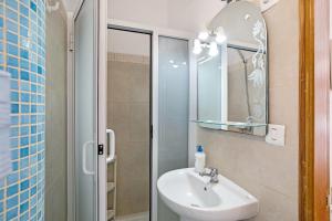 a bathroom with a sink and a shower with a mirror at Estudio 2 Costa Adeje in Adeje +14 photos