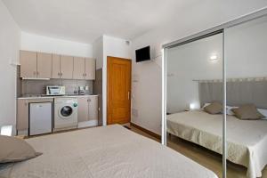 a small room with two beds and a kitchen at Estudio 2 Costa Adeje in Adeje