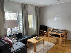a living room with a couch and a table at Chalets LumiHelmi Ruka in Ruka +11 photos