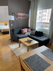 a living room with a couch and a table at Chalets LumiHelmi in Ruka