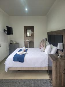 Ένα ή περισσότερα κρεβάτια σε δωμάτιο στο Palm Guesthouse