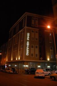 a building with a sign on the side of it at night at OTEL AMİLLER in Erzurum