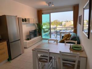 a kitchen with a table and a dining room with a view at Coralli Superior Seaview in Protaras