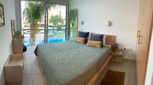 a bedroom with a large bed and a pool at Coralli Superior Seaview in Protaras +45 photos