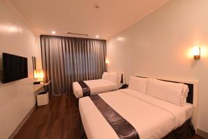 Ένα ή περισσότερα κρεβάτια σε δωμάτιο στο T Shine Resort and Spa