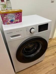 a washing machine with a box on top of it at City Apartment 1 in Vienna +1 photo
