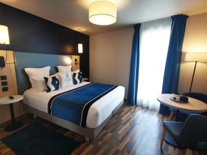 a hotel room with a bed and a window at Residhome Asnieres in Asnières-sur-Seine