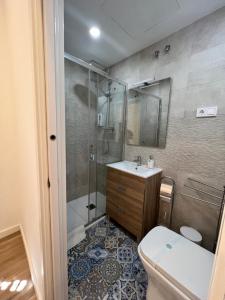 a bathroom with a toilet a sink and a bath tub at Hostal del Palau in Barcelona