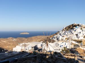 a view of a village with white buildings and the ocean at Aelia House Serifos in Serifos Chora
