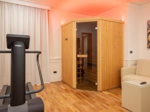a room with a gym with a treadmill and a living room at Mirabella Hotel in Mirabella Eclano