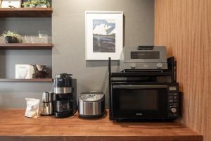 a kitchen with a microwave and a printer on a counter at Good Neighbors in Kanazawa