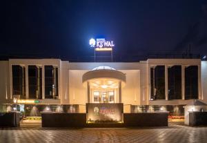 a building with a sign on top of it at night at Hotel Kewal in Nashik