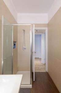 a white bathroom with a shower and a sink at CASA KIKA Comoda, Luminosa e Accogliente in Milan