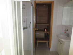 a bathroom with a sink and a shower and a toilet at Aparthotel YlläStar in Äkäslompolo