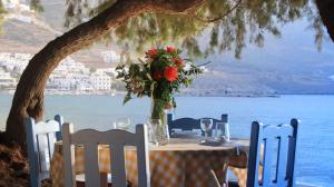 a table with a vase of flowers on it at Lakki Village in Aegiali