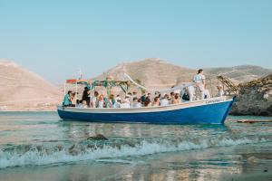 a group of people on a boat in the water at Lakki Village in Aegiali