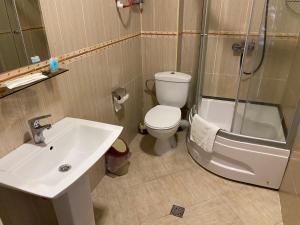 a bathroom with a toilet and a sink and a shower at Apartment In Batumi MGZAVREBI in Batumi +99 photos