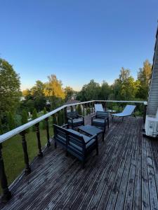 a deck with benches on top of a house at Near the lake apartment with hot tub and sauna in Tõrva