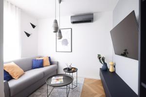 a living room with a couch and a table at 11 11 Apartment Zadar in Zadar