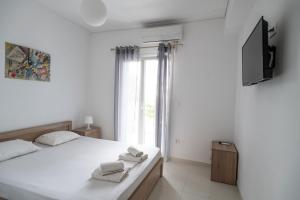 Säng eller sängar i ett rum på Iridanos Apartments
