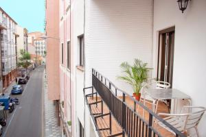 a balcony with a table and chairs and a street at ROMÁNICO CENTRO in Zamora