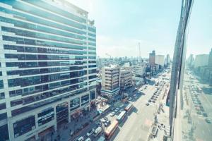 a view of a city street with a tall building at JSM Studio Hongdae in Seoul