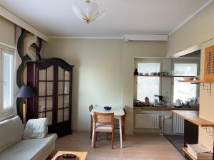 a kitchen and living room with a table and a couch at Travel Center Apartment in Lahti