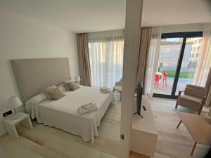 sypialnia z łóżkiem i przesuwanymi szklanymi drzwiami w obiekcie AZAHAR BEACH Red Apartments & Spa w mieście Alcossebre
