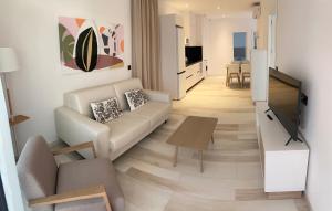 sala de estar con sofá y TV en AZAHAR BEACH Red Apartments & Spa, en Alcossebre